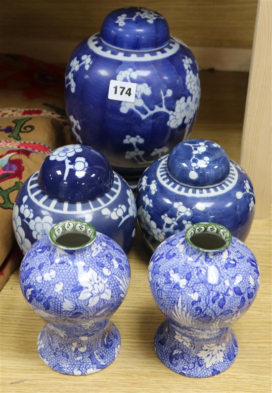 Three Oriental blue and white jars and covers, and a pair of vases
